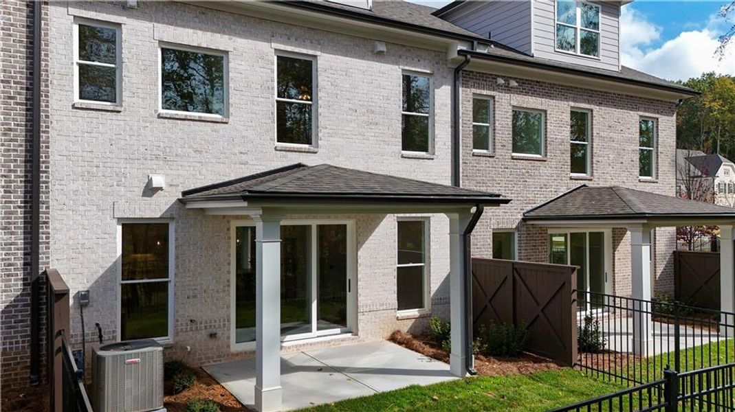 Exterior details and patio area of a home in Ward's Crossing Townhomes, Johns Creek (Image 2).