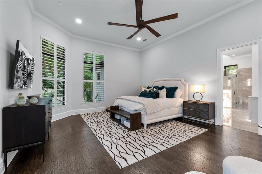 Bedroom featuring ensuite bath, ceiling fan, dark hardwood / wood-style flooring, and ornamental molding