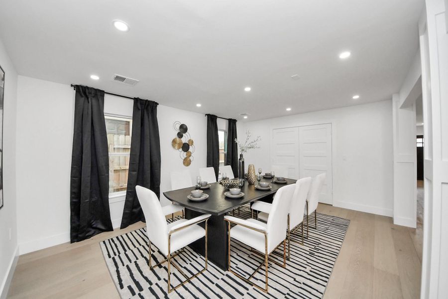 The double doors behind the table open to a large storage closet that could be turned into a wet bar or custom wine room. The double doors behind the table open to a large storage closet that could be turned into a wet bar or custom wine room.