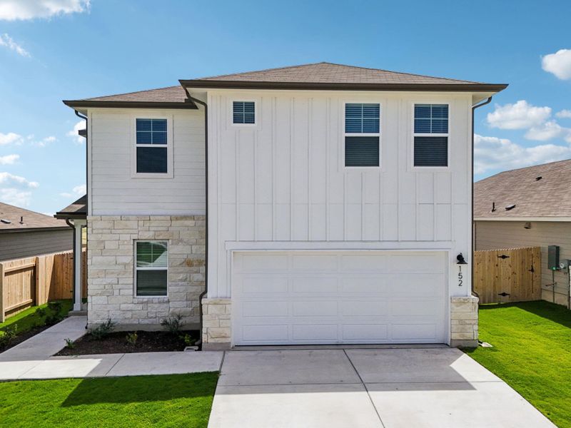 View of front facade with a shingled roof, a garage, driveway, board and batten siding, and stone siding View of front facade with a shingled roof, a garage, driveway, board and batten siding, and stone siding