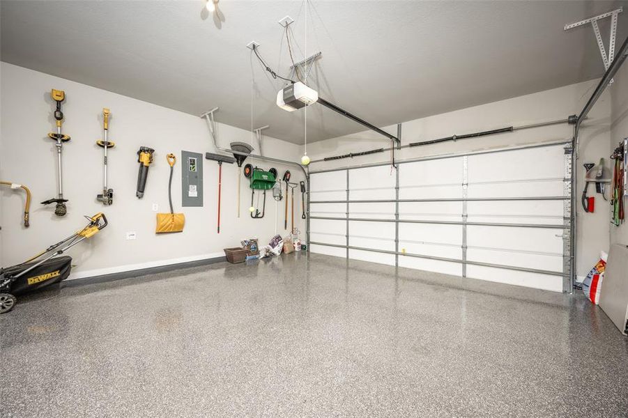 Garage featuring epoxy flooring and single garage door