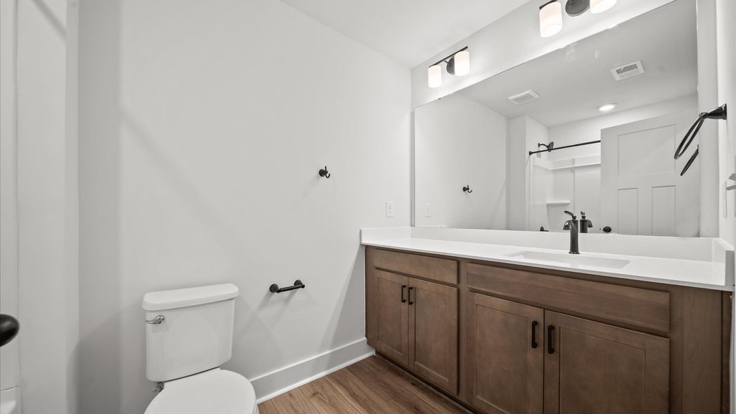 Accomplished bathroom design with sleek tile, high-quality cabinetry, and refined hardware