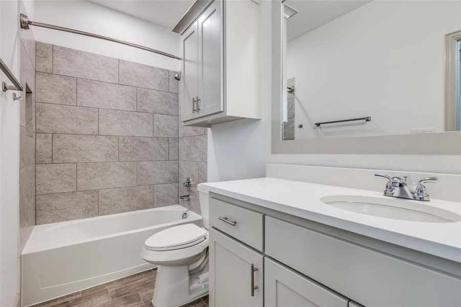 Full bath with shower / tub combination, vanity, and wood tiled floors Full bath with shower / tub combination, vanity, and wood tiled floors