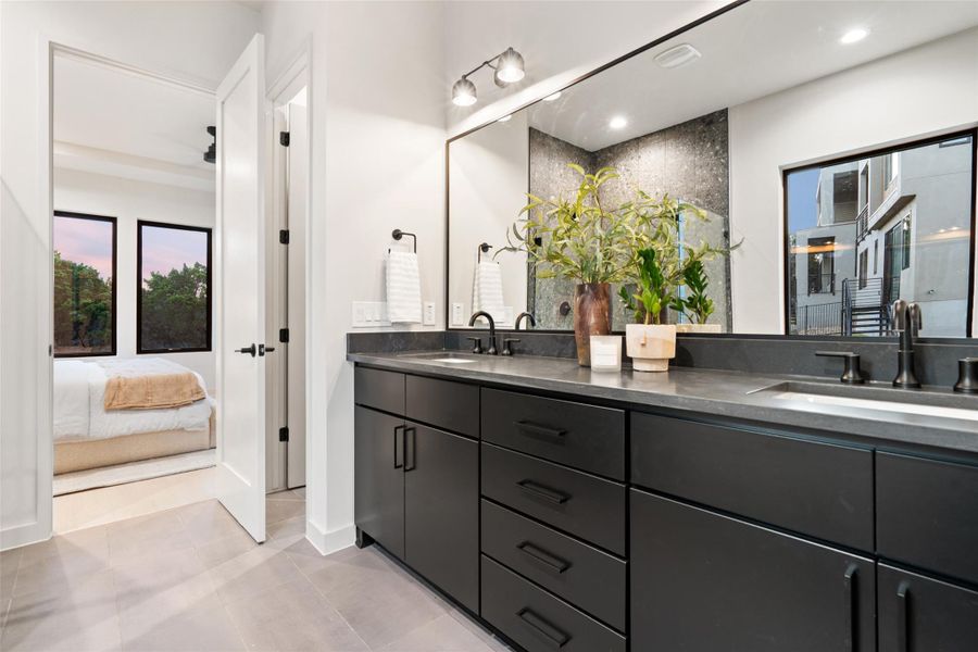 A chic primary bathroom vanity with dual sinks, modern cabinetry, and sleek hardware awaits. A chic primary bathroom vanity with dual sinks, modern cabinetry, and sleek hardware awaits.