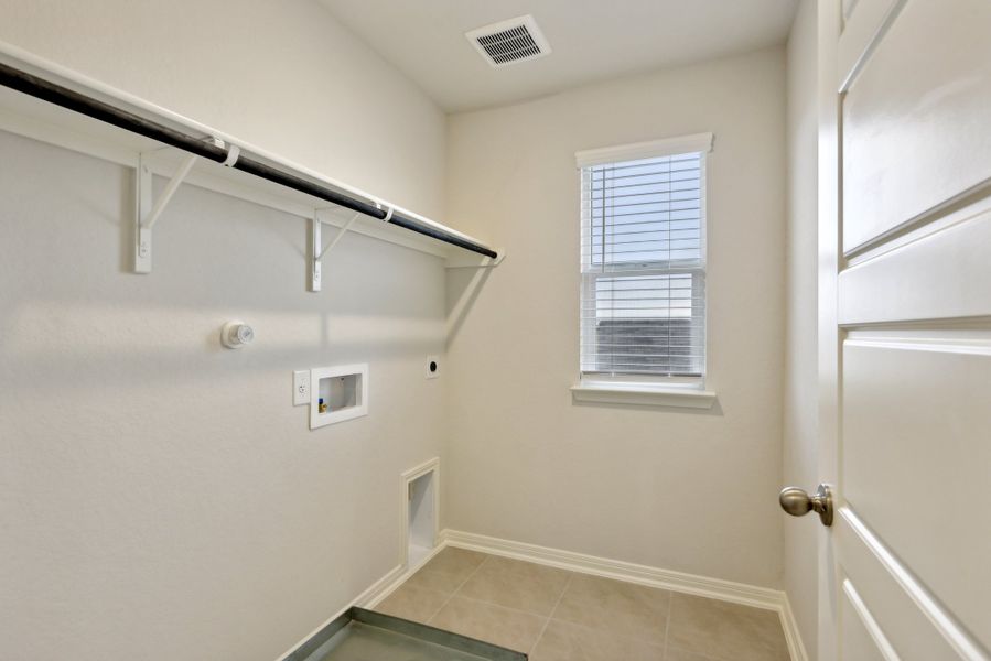 Laundry room in the Red River floorplan at a Meritage Homes community.