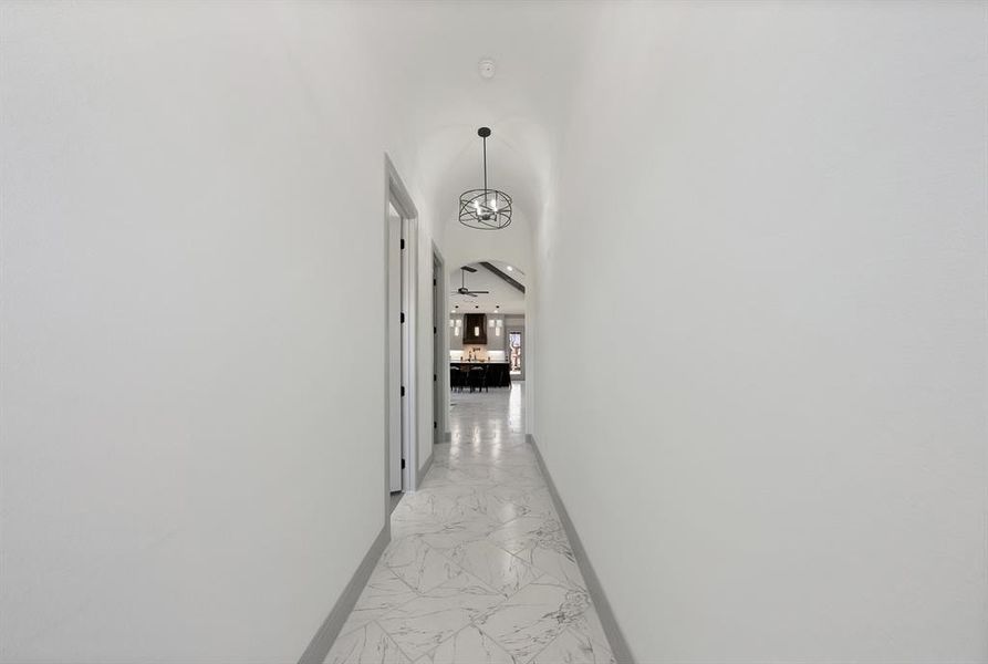 Corridor featuring light marble finish flooring and arched walkways