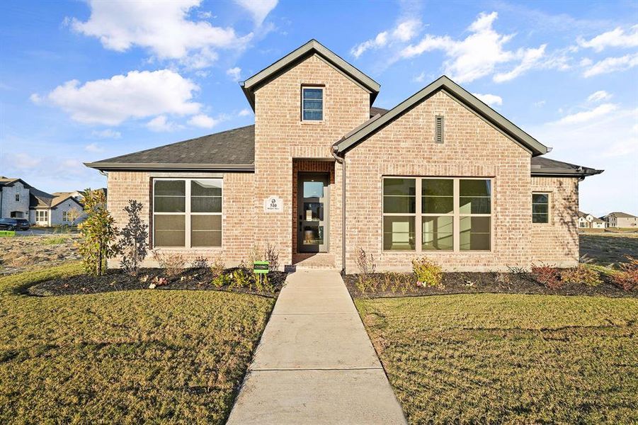 View of front of home featuring brick siding, a front yard, and roof with shingles View of front of home featuring brick siding, a front yard, and roof with shingles