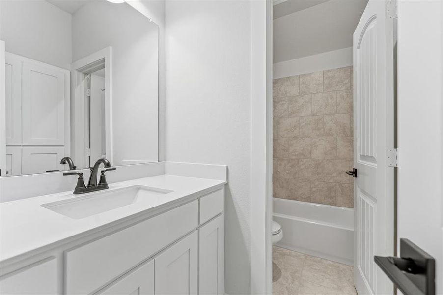 Bathroom with vanity and shower / washtub combination