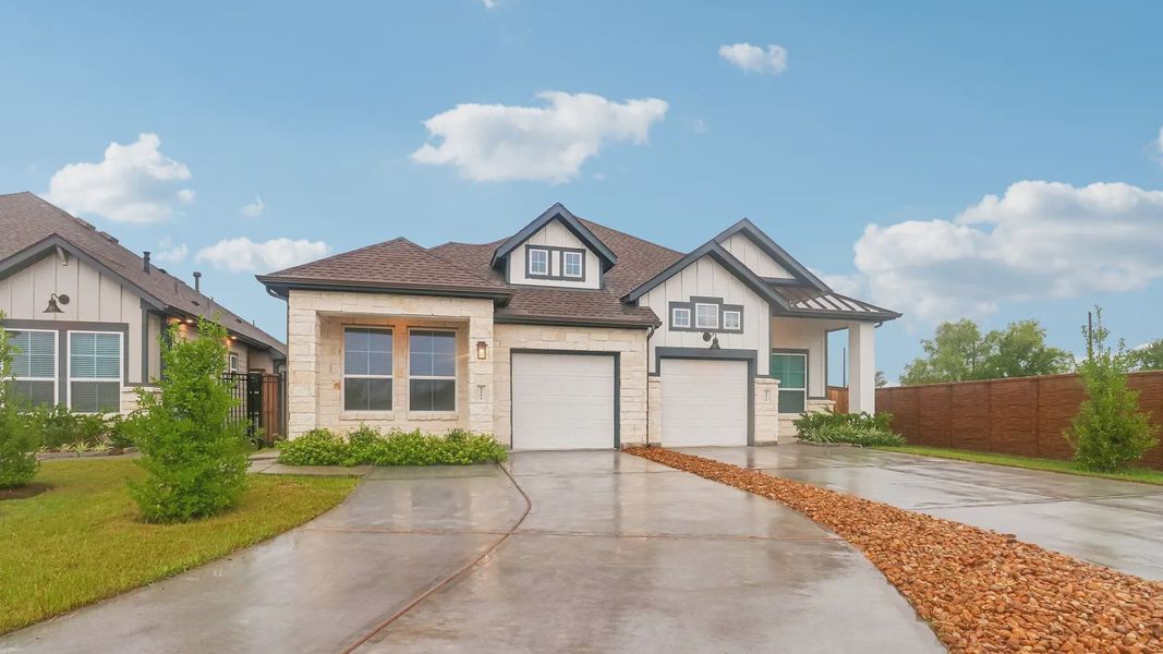Front exterior of a new home in Meridiana Townhomes, Manvel, TX, highlighting curb appeal (Image 2).