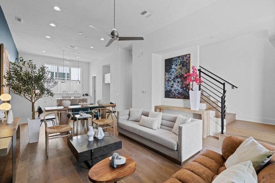 Living area featuring wood-type flooring, ceiling fan, and recessed lighting