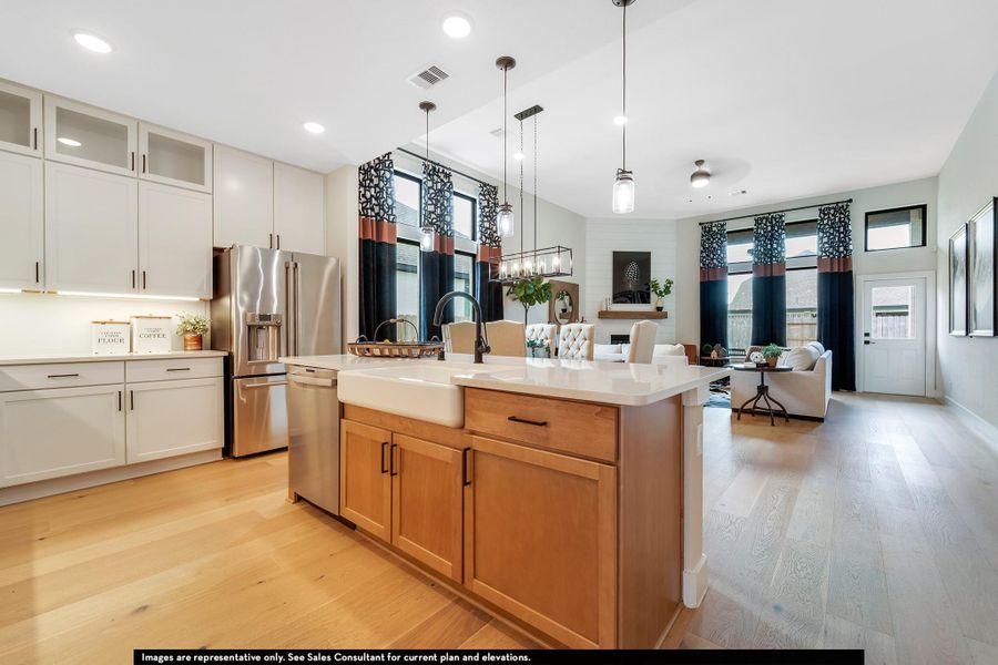 Kitchen featuring light wood-style flooring, stainless steel appliances, pendant lighting, open floor plan, and recessed lighting Kitchen featuring light wood-style flooring, stainless steel appliances, pendant lighting, open floor plan, and recessed lighting