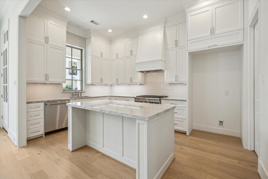 Kitchen features Thermador stainless steel appliances and Quartzite countertops.