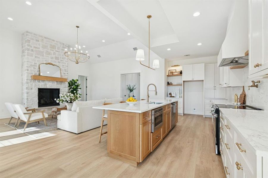 Don't miss the island-set microwave, the hutch-style appliance cabinets, the beautiful floating shelves - and of course the pot filler.