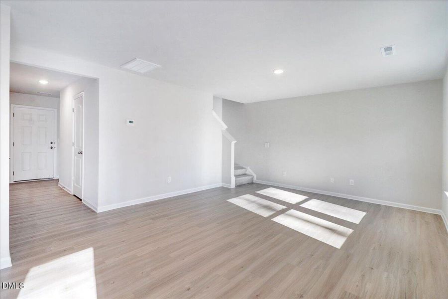 14-Open concept living area with vinyl f