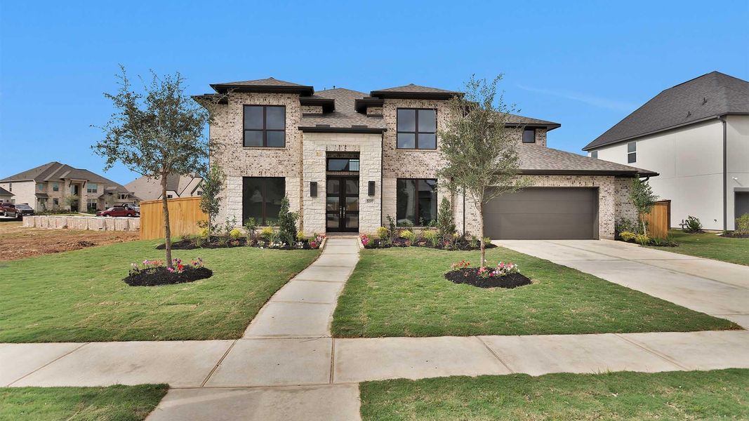 Front exterior of a new home in Meridiana 70', Manvel, TX, highlighting curb appeal (Image 2).