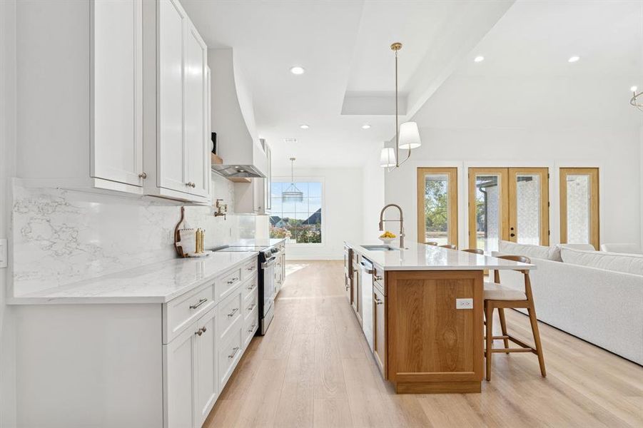 Level 4 Enza Oro polished finish quartz counters and backsplash; beautiful bevel details and hardware on the European style cabinets.