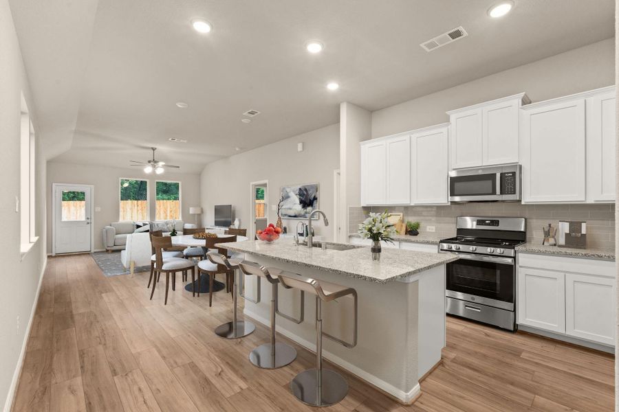Open floor plan from the island kitchen through the mail living area. Perfect for family or entertaining.  *Virtually staged