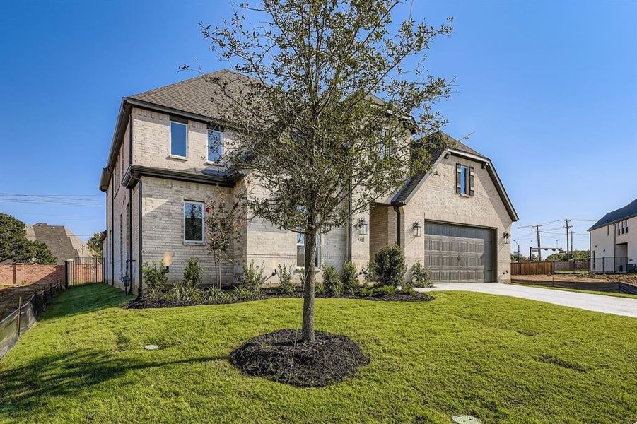 View of front of home with brick siding, concrete driveway, and a garage View of front of home with brick siding, concrete driveway, and a garage