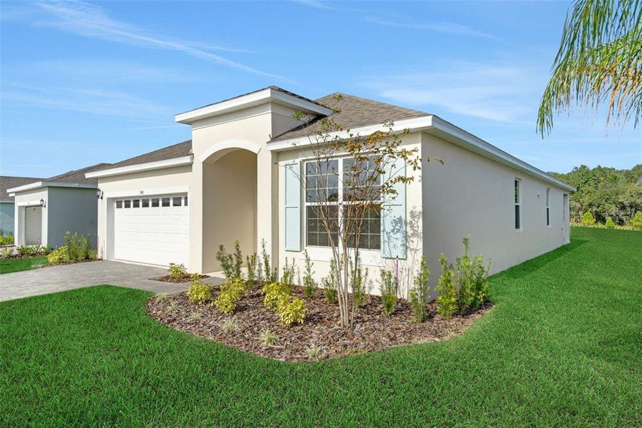Front exterior of a new home in Reserve at Hammock Oaks, Lady Lake, FL, highlighting curb appeal (Image 17). Front exterior of a new home in Reserve at Hammock Oaks, Lady Lake, FL, highlighting curb appeal (Image 17).