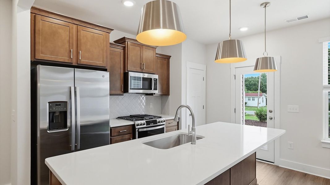 Elegant and compact island anchors this tasteful kitchen with high standards and timeless appeal in Piedmont, SC Elegant and compact island anchors this tasteful kitchen with high standards and timeless appeal in Piedmont, SC