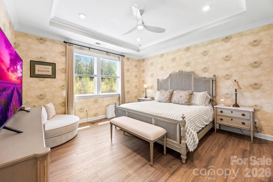 Primary bedroom with designer wall coverings upgraded by sellers