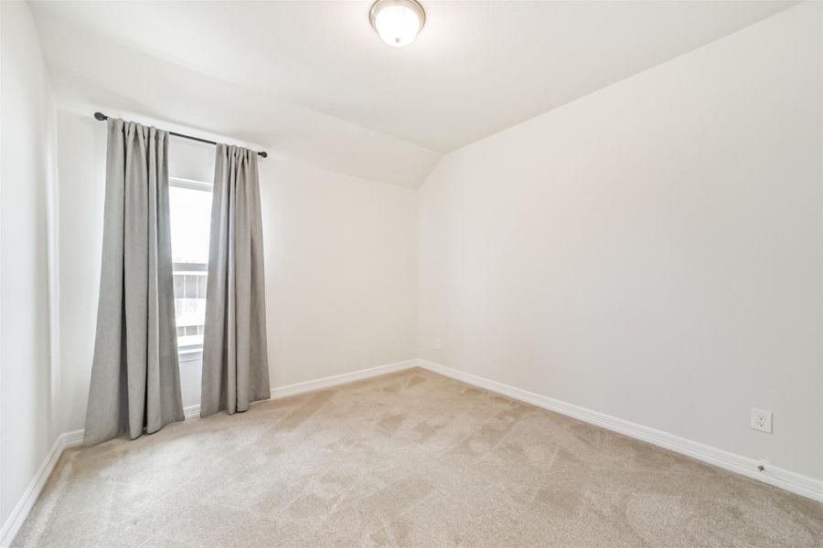 Guest bedroom number three mirrors the other bedrooms with plush carpet, neutral paint, and a window outfitted with drapes. Guest bedroom number three mirrors the other bedrooms with plush carpet, neutral paint, and a window outfitted with drapes.