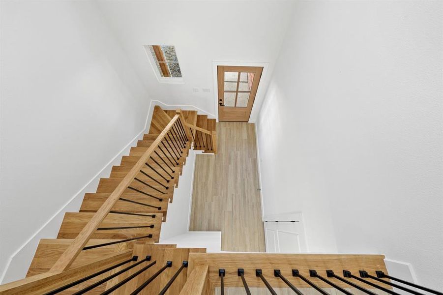 Stairway featuring baseboards and wood finished floors