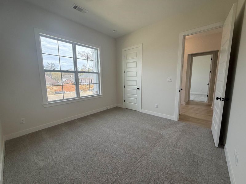 Unfurnished bedroom featuring baseboards and light colored carpet