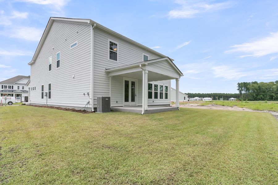 Exterior details and patio area of a home in Tidewater at Lakes of Cane Bay, Summerville (Image 25).