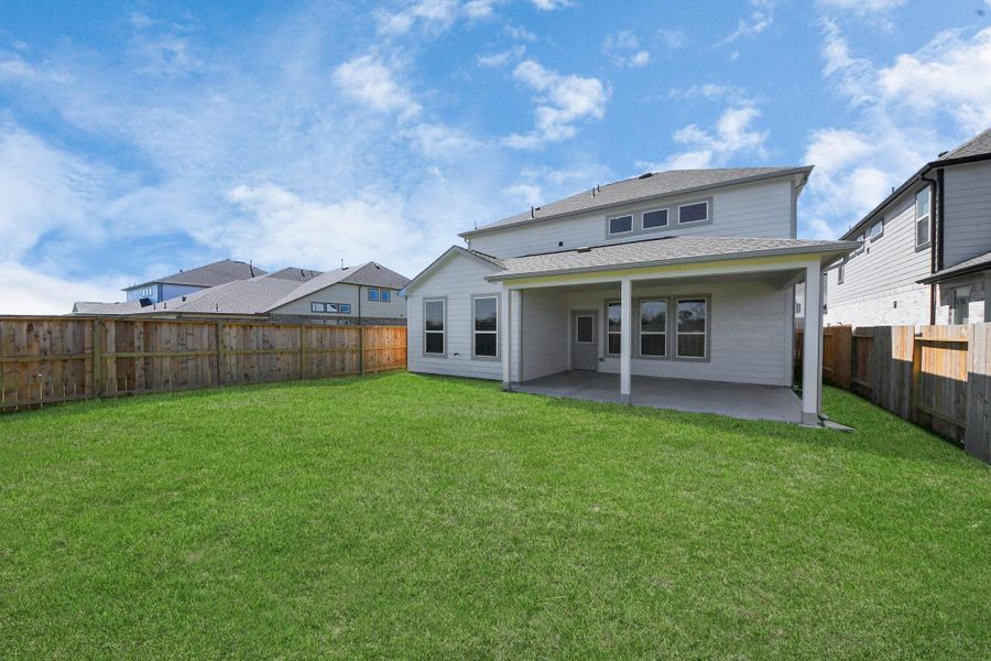 Come and see this spacious backyard with its beautiful covered patio. There is plenty of room for the kids to play and adults to relax. Perfect for your outdoor living space, patio furniture, bbq pit, and so much more. The possibilities are endless! Sample photo of completed home with similar floor plan. Actual colors and selections may vary.