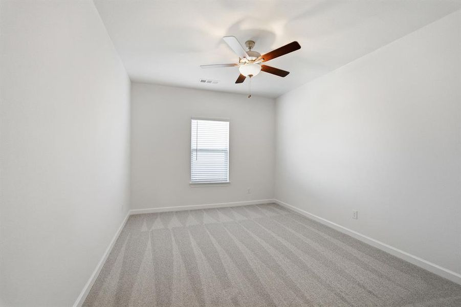 Room featuring light gray patterned carpeting and white painted walls