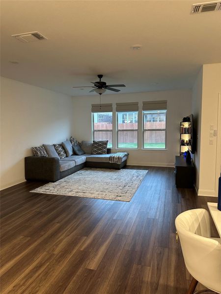 Spacious interior featuring wood-finish flooring, recessed lighting, and a ceiling fan Spacious interior featuring wood-finish flooring, recessed lighting, and a ceiling fan