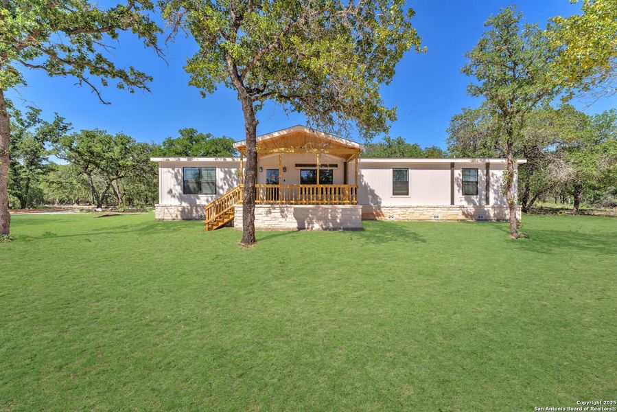 Front exterior of a new home in , La Vernia, TX, highlighting curb appeal (Image 14).