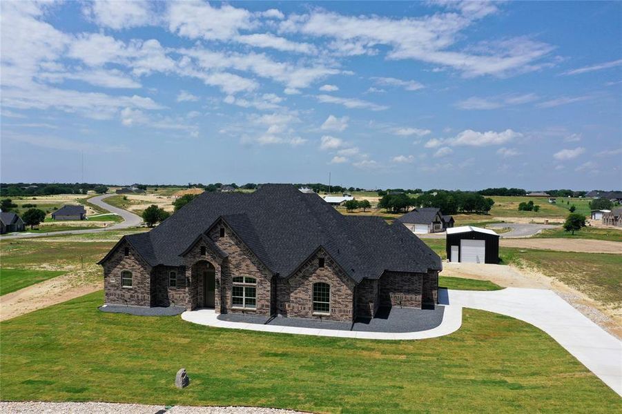 View of front of house featuring a garage and a front lawn