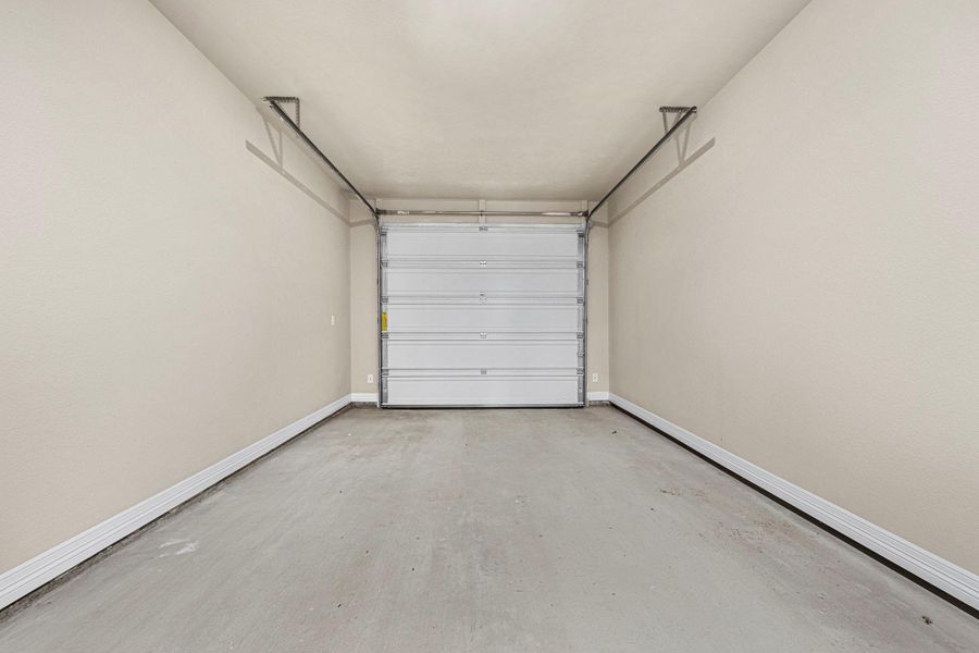 Garage featuring baseboards