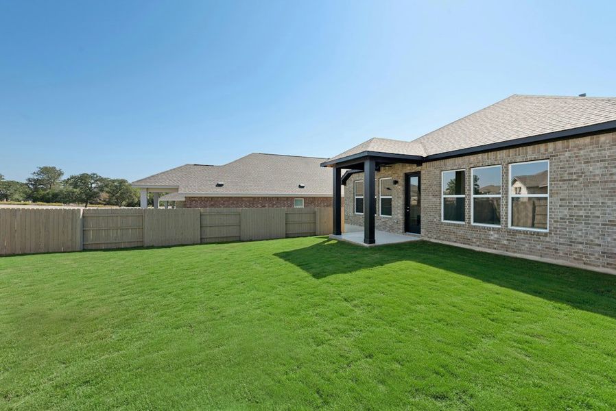 Exterior details and patio area of a home in The Colony, Bastrop (Image 25).