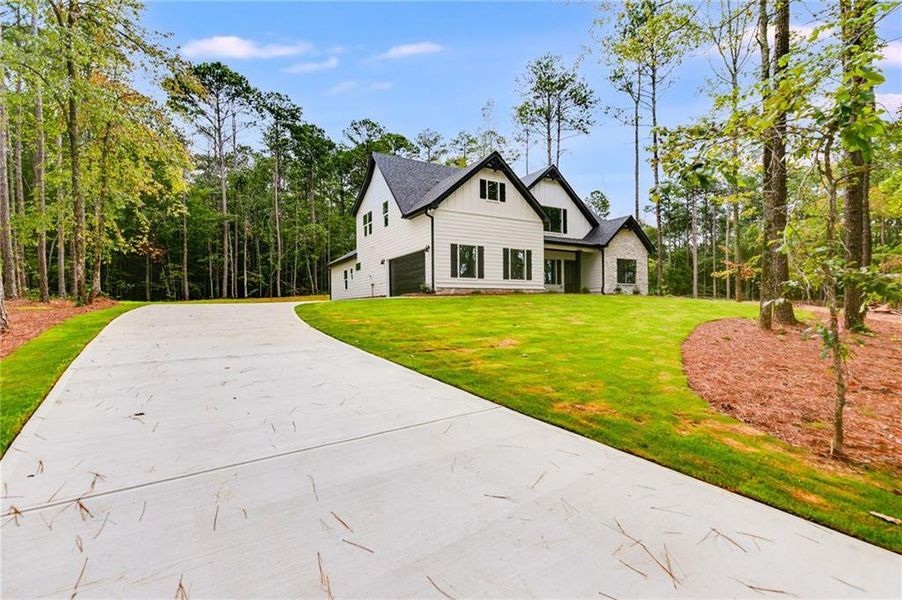 Front exterior of a new home in Liberty Station, Bremen, GA, highlighting curb appeal (Image 25).