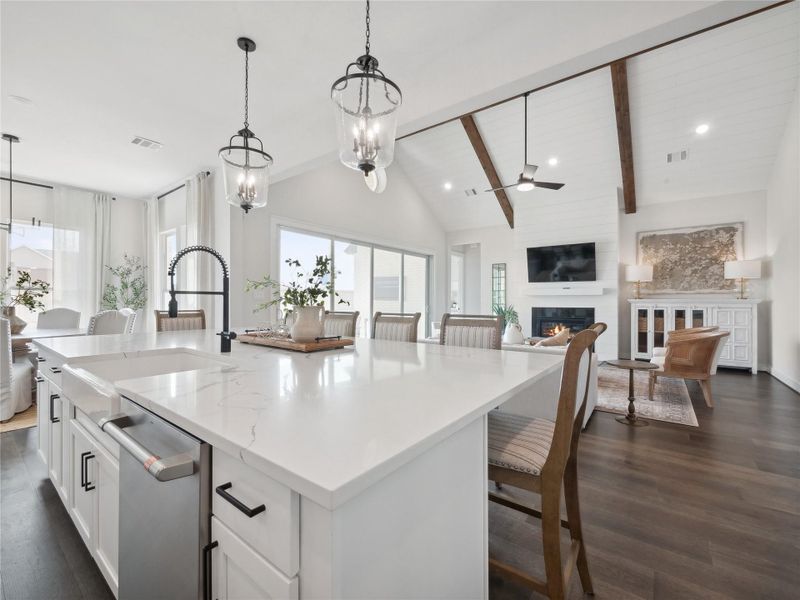 Kitchen overlooks great room with an adjacent dining area
