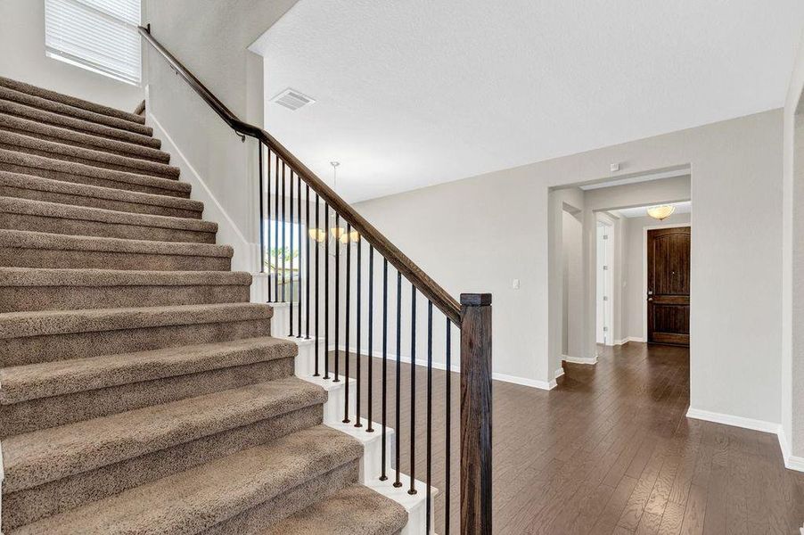 Stairs with wood-type flooring and plenty of natural light Stairs with wood-type flooring and plenty of natural light