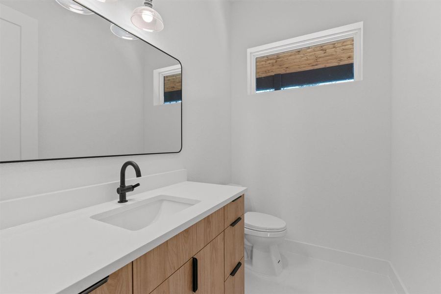 Bathroom featuring vanity and toilet Bathroom featuring vanity and toilet