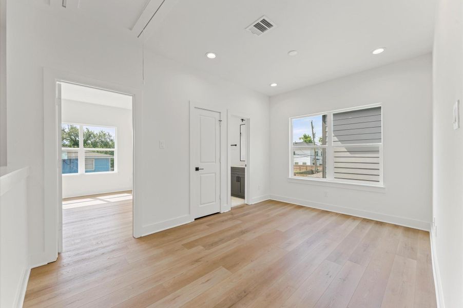 Flex space with dual access bath and view of secondary bedroom.
