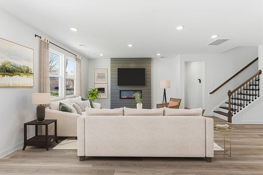 A living room with a large staircase.