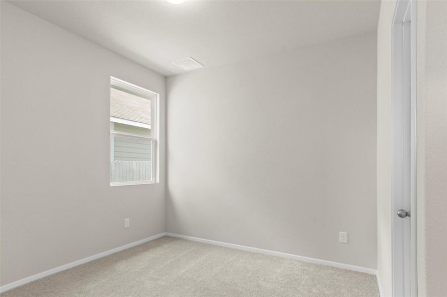 Unfurnished room featuring light colored carpet and baseboards