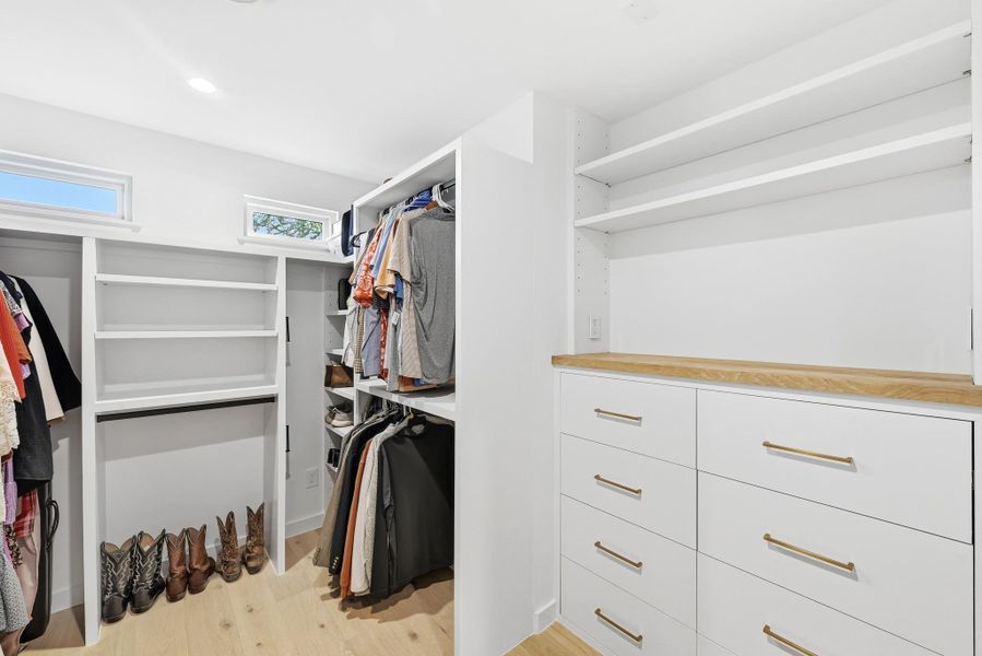 Walk in closet featuring light wood-style floors