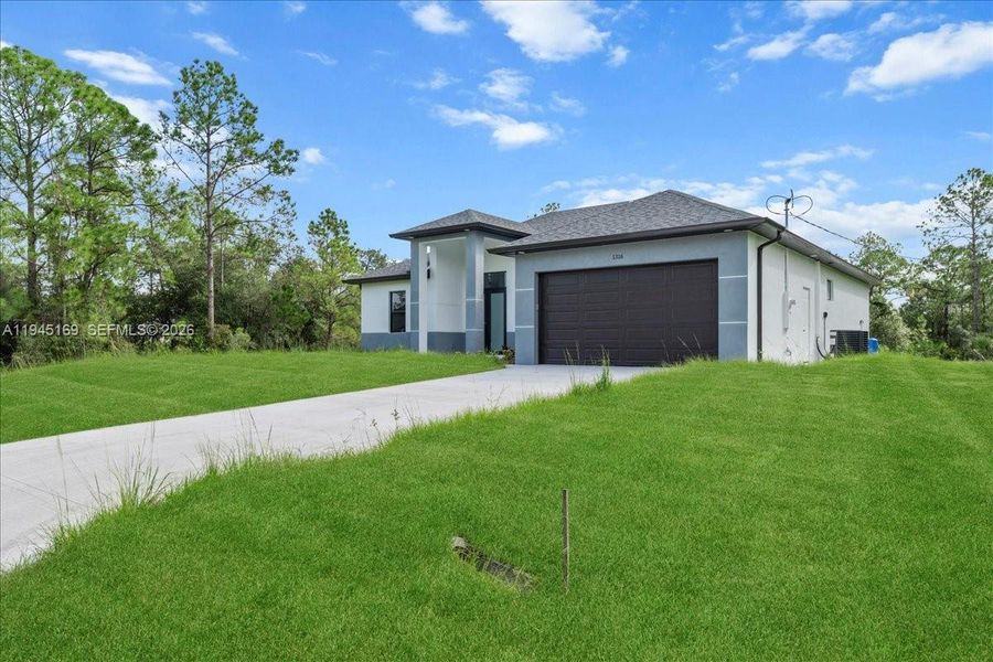 Front exterior of a new home in , Lehigh Acres, FL, highlighting curb appeal (Image 23).
