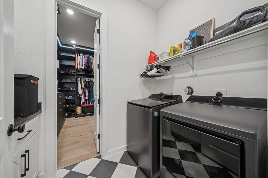 The laundry room with fashionable checkered floor, connects to the hall AND the primary closet.