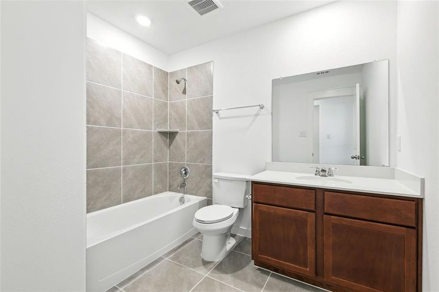 Full bathroom featuring vanity, shower / tub combination, and light tile patterned floors
