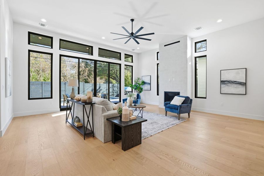 Living area featuring plenty of natural light, light wood finished floors, recessed lighting, and a ceiling fan