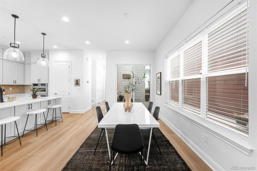 Spacious dining area bridges the kitchen and backyard