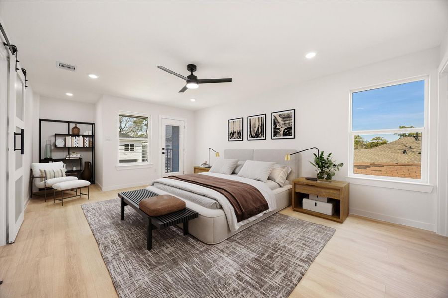 Spacious primary bedroom offering high ceilings, wood-look flooring, recessed lighting, and abundant natural light, with direct access to a private balcony. *Virtually Staged Spacious primary bedroom offering high ceilings, wood-look flooring, recessed lighting, and abundant natural light, with direct access to a private balcony. *Virtually Staged